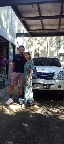 a man and a woman standing in front of a car at Spring Villas Kandy in Kandy