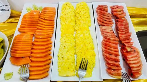 a white plate topped with different types of carrots and rice at Spring Villas Kandy in Kandy