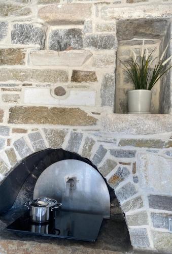 a stone oven with a pot on top of it at Aegean Breeze House in Kampos Paros