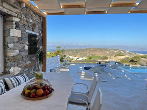a bowl of fruit on a table on a patio at Aegean Breeze House in Kampos Paros