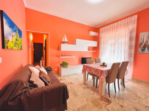 a living room with a couch and a table at Domus Aurea in Isola delle Femmine
