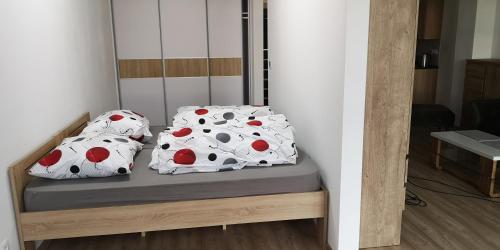 a bed with two polka dot pillows on it at dvojizbáč in Trenčín