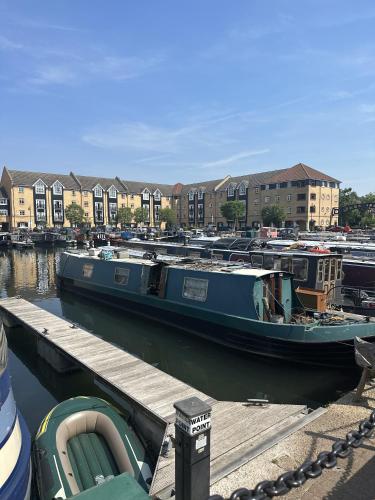 a blue boat is docked at a dock at Large 2 Bedroom Marina View Apartment in Hemel Hempstead