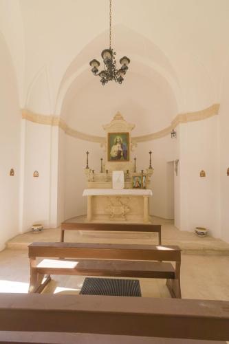 a church with a altar in a room with a chandelier at Villa Romasi in Leuca
