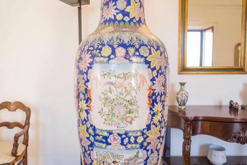 a large blue and white vase sitting next to a table at Villa Romasi in Leuca