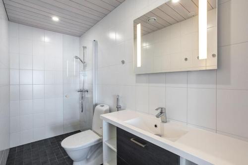 een witte badkamer met een toilet en een wastafel bij Kasnäs Marina Seafront Lux Villa in Kasnäs
