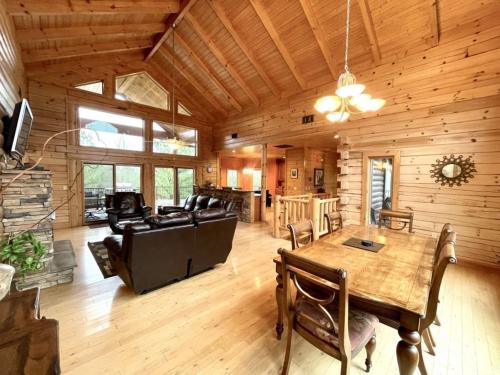 a large living room with a table and a couch at Grand View Home with 360 Degree Mountain View in Tellico Plains
