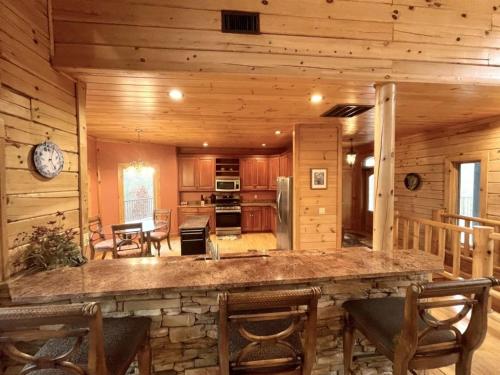 a kitchen and living room in a log cabin at Grand View Home with 360 Degree Mountain View in Tellico Plains