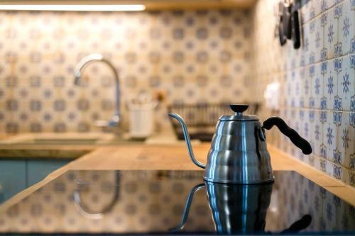 a metal tea kettle on a counter in a kitchen at Chata Buena Vista 