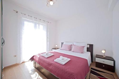 1 dormitorio con 1 cama grande y 2 toallas. en Apartman Marin-Dalmatian way of vacation, en Gornje Selo