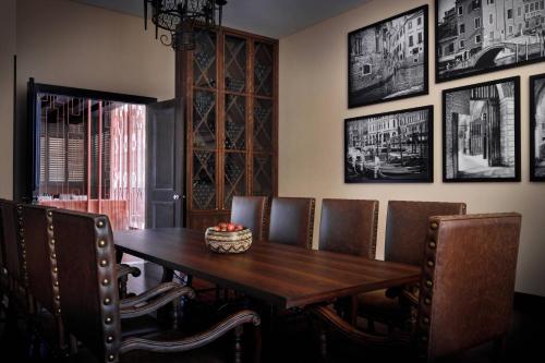 a dining room with a wooden table and chairs at Kigali Marriott Hotel in Kigali
