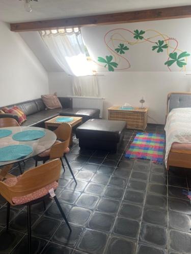 a living room with a couch and tables and a bed at Apartmány Agroklubu na Radosti in Komorovice