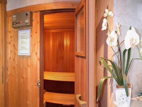 a wooden room with a sauna with a plant at Hotel Le Festival in Cannes