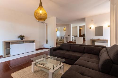 a living room with a couch and a table at The Po-Lo Villa indipendente al mare in Su Forti