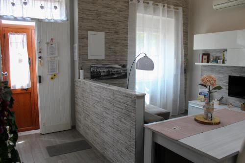 a kitchen and living room with a brick wall at CAMARDA SUITE in Bernalda