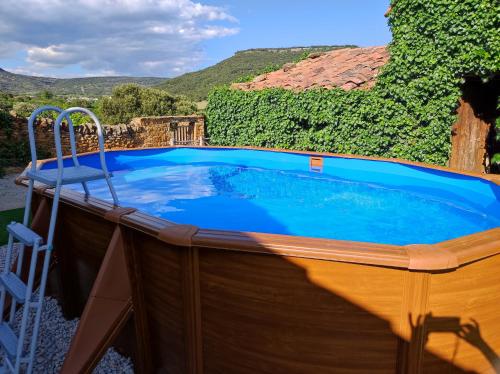a hot tub on the deck of a house at masia riu dels arbres in Benasal