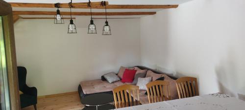 a living room with a couch and a table and chairs at Niedźwiedziówka in Mrągowo