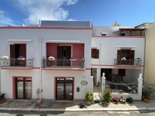 a large white building with two balconies on it at B&B Le Ortensie in San Vito lo Capo