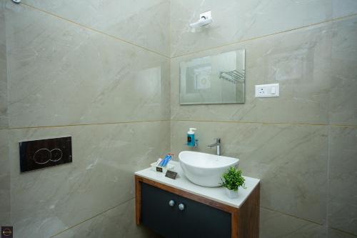 a bathroom with a sink and a mirror at Reunion Ocean Manor - Beach House in Udupi