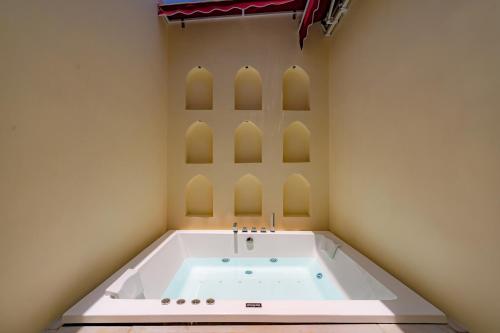 a bath tub in a room with arches at Stay Vista at Khohar Haveli - 18th Century Palace with Modern Amenities in Gurgaon