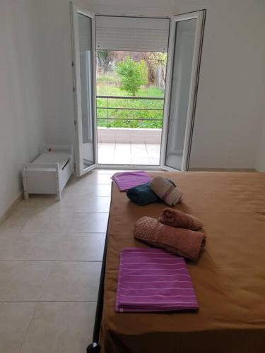 a bedroom with a bed with two pillows on it at Konstantinos Apartmend Chalkidiki in Sozopoli