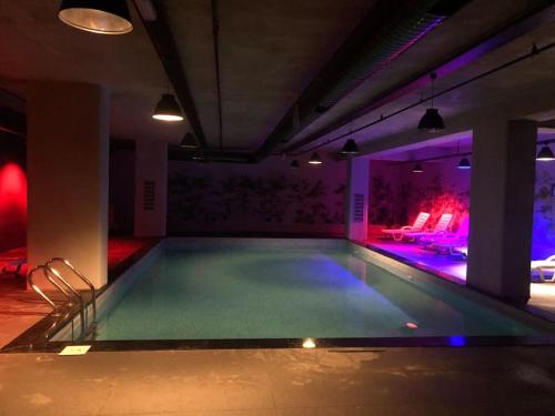 a swimming pool in a room with purple lights at Furnished Apartment for rent in Istanbul