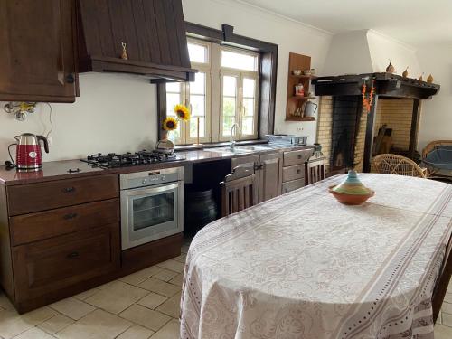 a kitchen with a table with a bowl on it at Casa das Andorinhas - Campo e Piscina in Bajouca de Cima