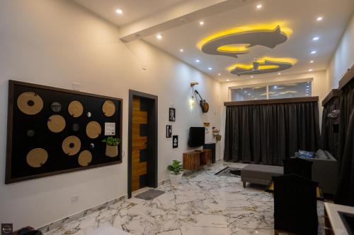 a living room with a painting of a dog on the ceiling at Reunion Ocean Manor - Beach House in Udupi
