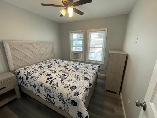 1 dormitorio con 1 cama y ventilador de techo en Dupont Beach House B, en Seaside Heights