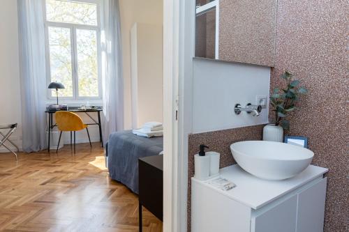 a bathroom with a sink and a bed in a room at Lago Design Guest House - Como Center in Como