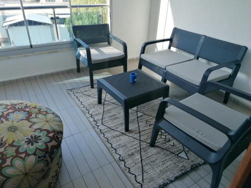 a room with three chairs and a table and a bench at Eryaman, Wide Luxury Concept in Etimesut