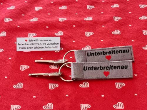 a pair of keys sitting on a red blanket at Ferienhaus Ritzmais in Bischofsmais