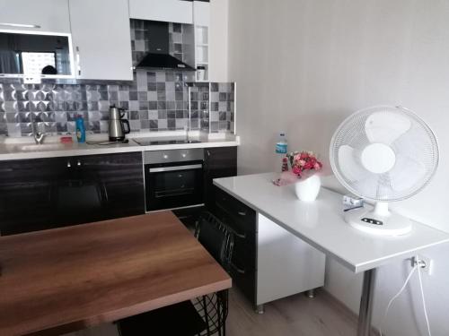 a kitchen with a fan and a white counter top at Eryaman, Wide Luxury Rezidance in Etimesut