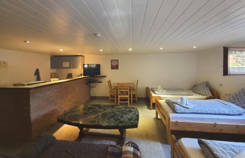 a living room with a couch and a table at Gästehaus Terrana in Wathlingen