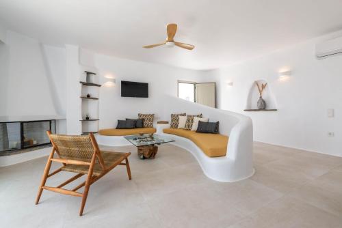 a living room with a couch and a chair at Cavos in Agios Sostis