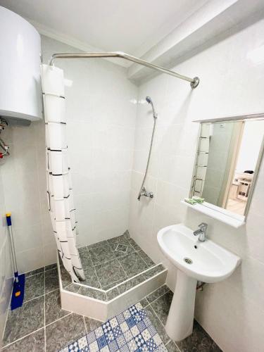 a bathroom with a sink and a shower at Apartment, Центр Отдыха Atlantis, Сары-Ой, 1-й этаж in Chon-Sary-Oy