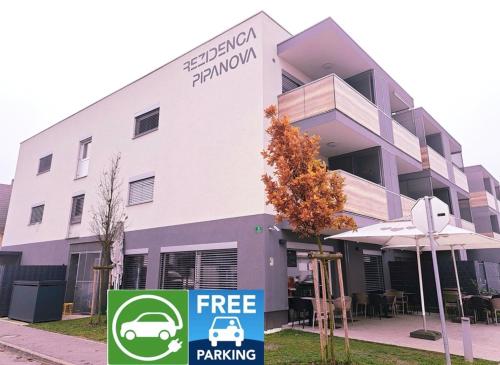 a building with a free parking sign in front of it at Stunning new apartment with free parking near city centre in Ljubljana