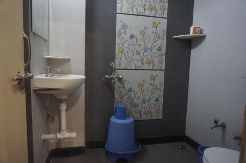 a bathroom with a sink and a toilet and a shower at Hotel Gujrat in Nagpur