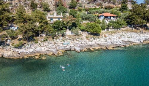 an aerial view of people kayaking in a body of water at Petra Mare Apartments in Alyki