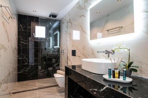 a bathroom with a sink and a shower at Villa Roselia - Luxury Escape with Magnificent Views, by ZanteWize in Laganas