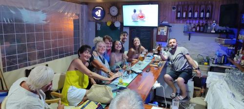 a group of people sitting around a long table at California Apart Otel in Oludeniz