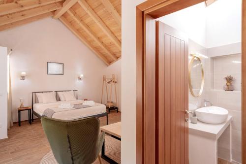 a bedroom with a bed and a bathroom with a sink at Luxury Rustic Villa Hvar island in Vrbanj