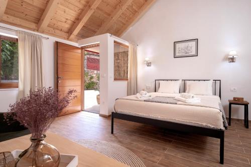 a bedroom with a bed and a table with a vase at Luxury Rustic Villa Hvar island in Vrbanj