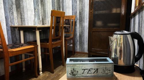 a room with a table and a chair and a box at Green bunny ArtHouse in Martvili