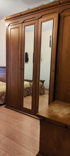 a mirror in a room with a wooden cabinet at Квартира в Батуми 