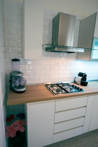 a kitchen with a stove and a counter top at Villetta nel Verde in Ascea
