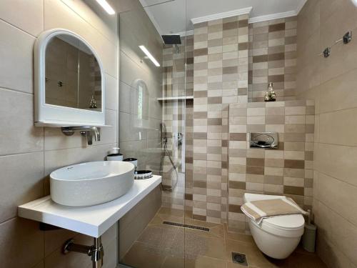 a bathroom with a sink and a toilet at Marialena's House in Limenas