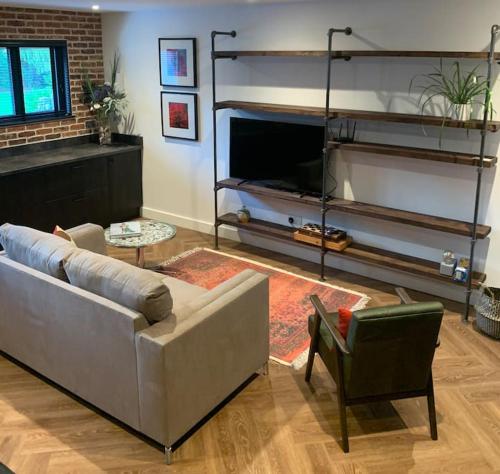 a living room with a couch and a chair at Country Apartment in Hurstpierpoint