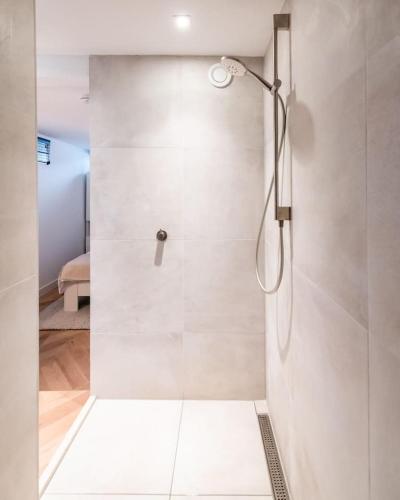 a shower with a glass door in a bathroom at Beautiful Amstel houseboat in Amsterdam