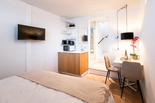 a bedroom with a bed and a desk with a microwave at Beautyful Amstel houseboat in Amsterdam